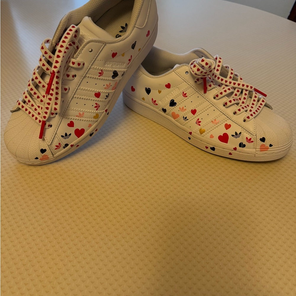 Adidas Valentines new sneakers in a size 8 1/2 with
Red heart laces and hearts.